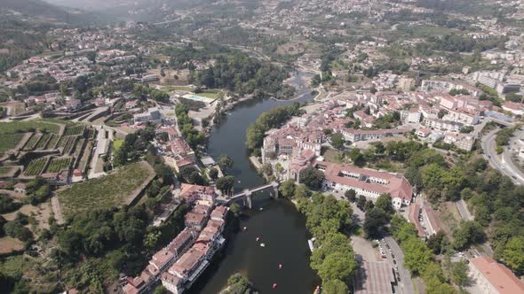 Rooftops of Amarante town surrounding Tamega river, aerial ascend view alt