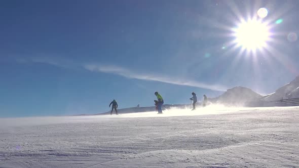 Skiers, Snowstorm and Sun