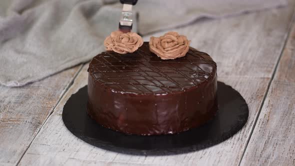 Woman Pastry Chef Decorating a Cake with a Cream Flowers