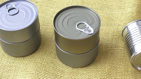 Canned food in cans on the yellow jute