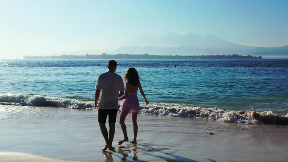 Fun Lady and Man on Romantic Honeymoon Spend Quality Time on Beach on Clean White Sand alt