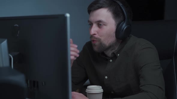 Caucasian Man in Headset Look at Laptop Screen Work Online From Home Office alt