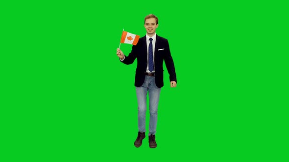 Young Happy Man Walking with Waving Flag of Canada on Green Screen