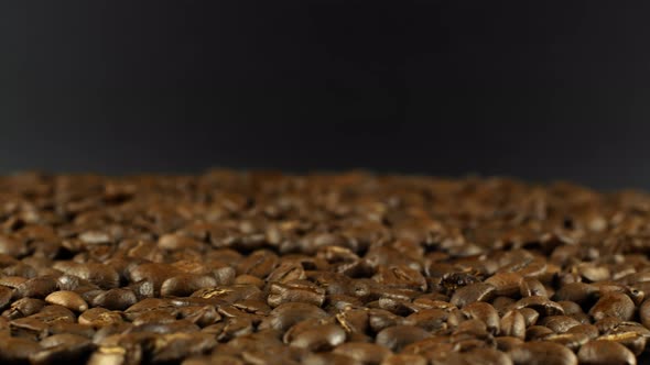 Rotation close-up of coffee beans 360. Golden selected aromatic beans rotate alt