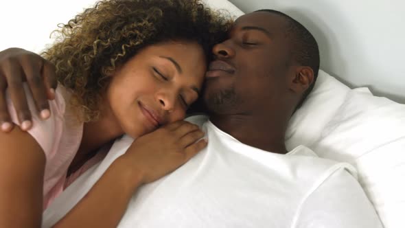 Young couple sleeping together on bed alt