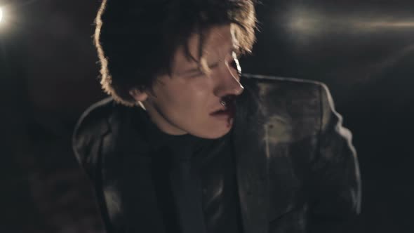 Portrait of a Rapt Man with Bloodstained Face Tied To Chair in Dark Catacombs alt