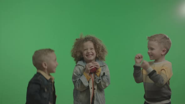 Happy Little Children Having Fun and Playing with Apple. alt