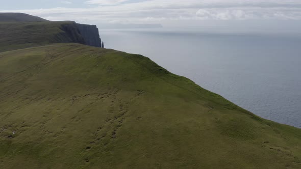Drone Along Green Landscape To Suduroy Cliffs alt