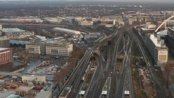 AERIAL: Over Cologne Railway Train System with Train Driving on Sunny Day  alt