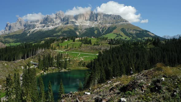 Girl in Front of Forest with Uprooted Pine Trees After Strong Wind in Lake Carezza Most Beautiful alt