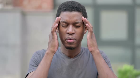 Portrait of Tired Young Young African Man Having Headache alt