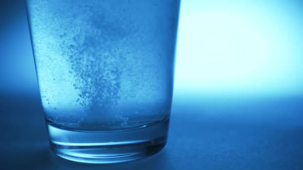 An Effervescent Tablet Dissolves at the Bottom of a Glass of Water alt