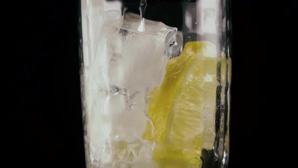 Pour Soda Into a Glass on a Black Background. 