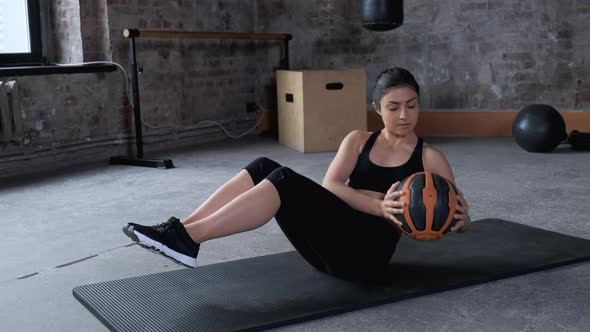 Young Indian Athletic Woman Doing abdominal Press Exercise Works Hands and Feet Uses Ball  alt