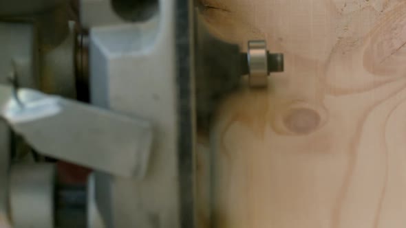 Vertical Shot Joiner Cuts Off the Sharp Corners of Wooden Beam with Milling Machine Closeup