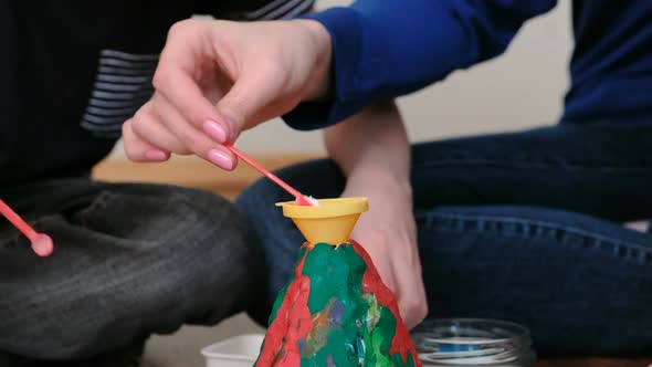 Hands of Mom and Son Applied the Chemicals Into the Funnel for the Experiment with a Clay