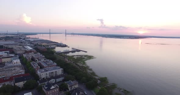Charleston SC rooftops and harbor at sunrise alt