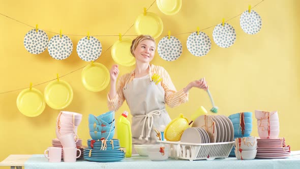 Pleased Attractive Woman with Friendly Look Cleans Kitchen