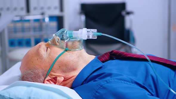Portrait of Old Male Patient Weating Oxygen Mask alt