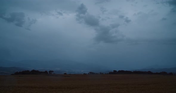 Timelapse on Countryside with Storm Clouds on Sky and Rain Drops on Lens alt