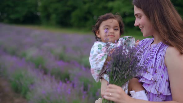 Mother Enjoying Time with Baby Girl in Lavender Field alt