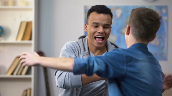 Multiracial Teenagers Making Up After Quarrel, Happy Smiling Friends Hugging alt