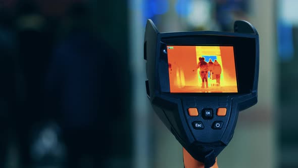 People in a Public Area Are Being Shown Through Thermal Radiation. Body Temperature Detecting, Covid alt