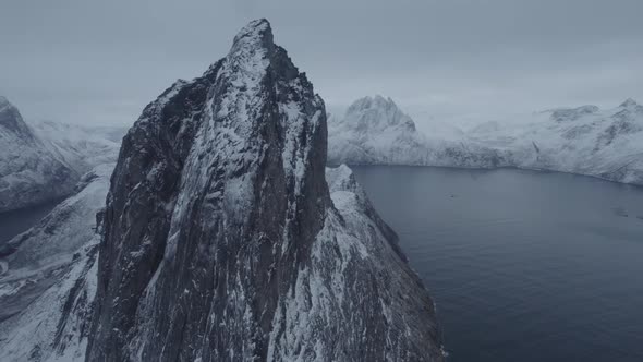 Aerial view close around the Segla mountain, gloomy winter day in Senja, North Norway - circling, dr alt