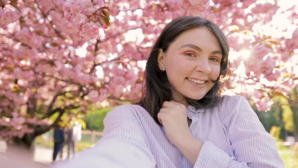 Girl filming selfie video photo for social media. Japan vacation slow motion alt