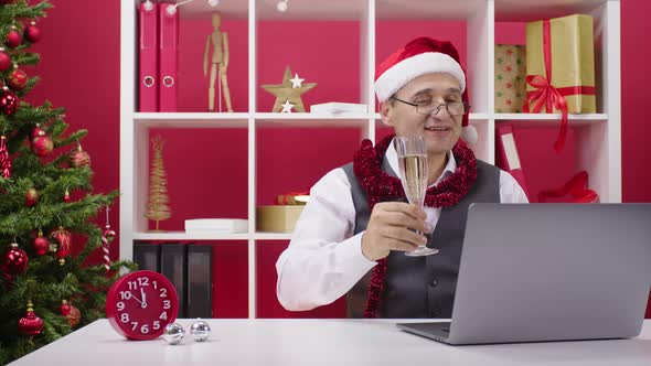 Tired 40s Corporate Employee in Santa Hat Participates in Online Christmas Party