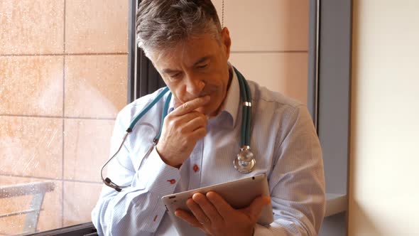 Doctor using digital tablet alt