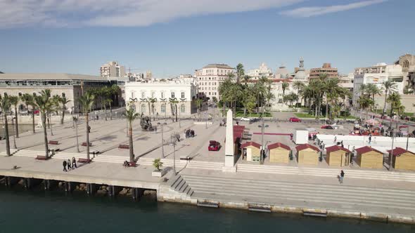 Aerial drone view of Cartagena touristic port with El Zulo sculpture, Spain