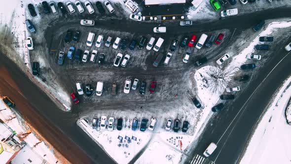 Aerial Top View of Small Supermarket Parking Lot with Cars at Winter Evening alt