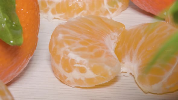 Close up macro shot revealing 2 segments of a Mandarin Orange on a table, a fresh healthy citrus fru alt