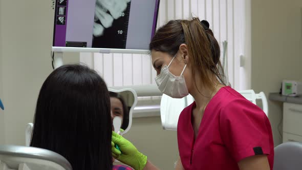 Patient is Looking in the Mirror While Dentist is Explaining Treatment alt