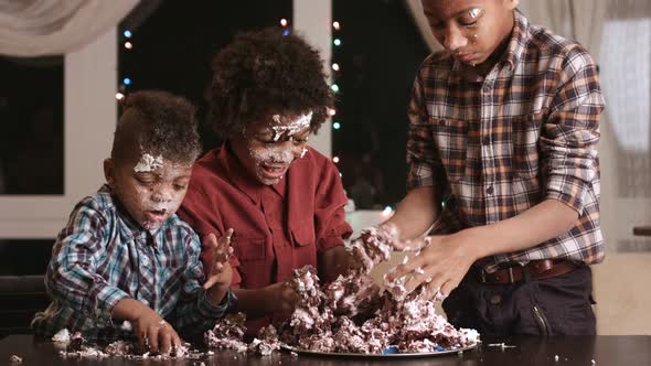 Afro Kids Greedily Eating Cake. alt