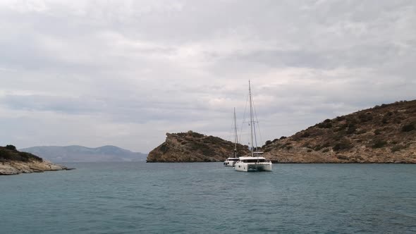 Catamaran Sail Yacht Anchored on Deep Blue Sea Water alt