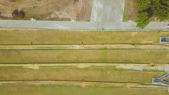 Newlywed Couple on Hilly Embankment with Stairs Upper View alt