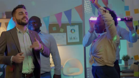 Multiracial Group of Office Workers Having Fun at Business Party Dancing and Laughing in the Evening alt