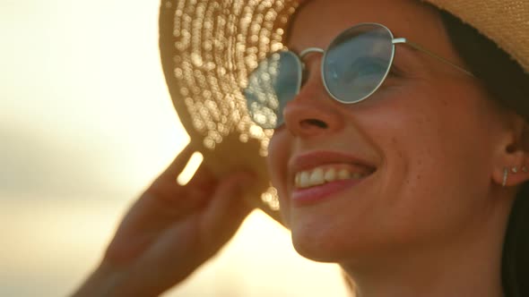 Portrait of a smiling woman against the background of the sky, slow motion alt