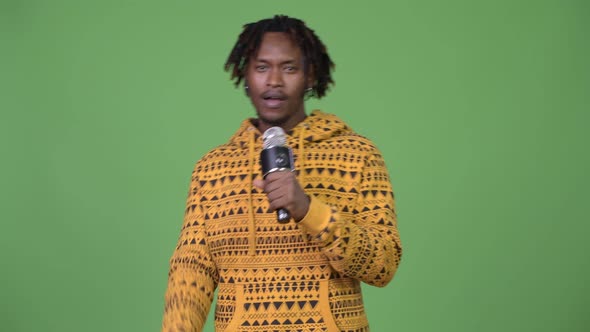 Young Handsome African Man Singing on Microphone alt