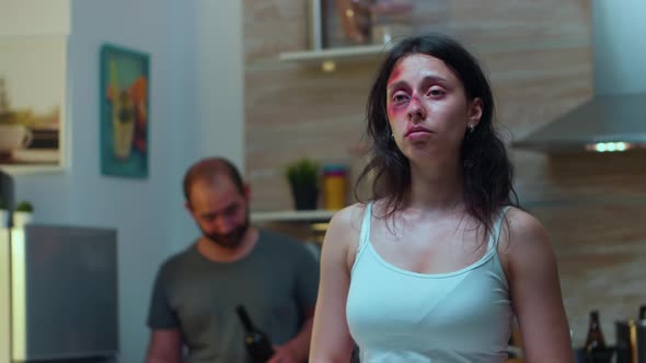 Traumatised Woman Looking at Knife alt