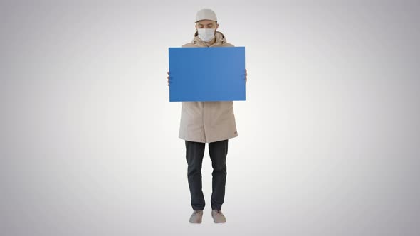 Casual Man with Copy Space Billboard Wearing Protective Mask on Gradient Background. alt