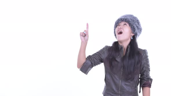 Happy Beautiful Asian Woman Pointing Up and Looking Surprised alt