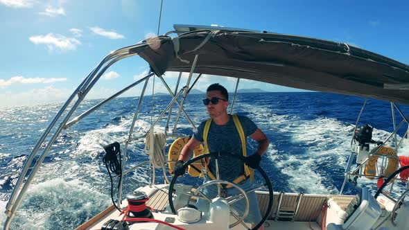 A Man Is Dancing While Managing a Yacht in the Ocean alt