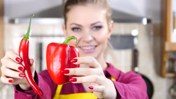 Woman Holds Chilli and Bell Pepper