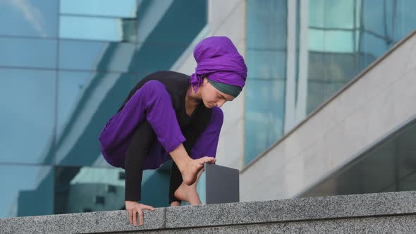 Young Strong Business Woman Islamic Muslim Student Stands in Balance Handstand Asana Acrobatic alt