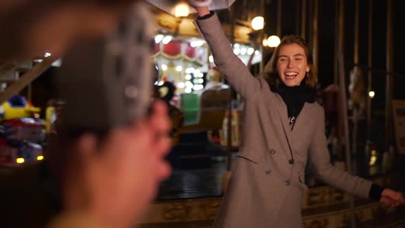 Girl Having Fun Near the Carousel alt