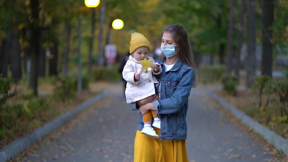 Masked Mother Holds Hand Lovely Daughter on Street Walk During Second Wave Quarantine Coronavirus alt