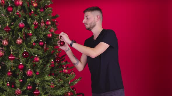 Attractive Male Homosexual Couple Decorating Xmas Tree Together, Merry Christmas